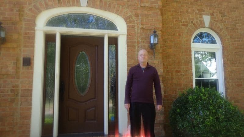 person in front of house