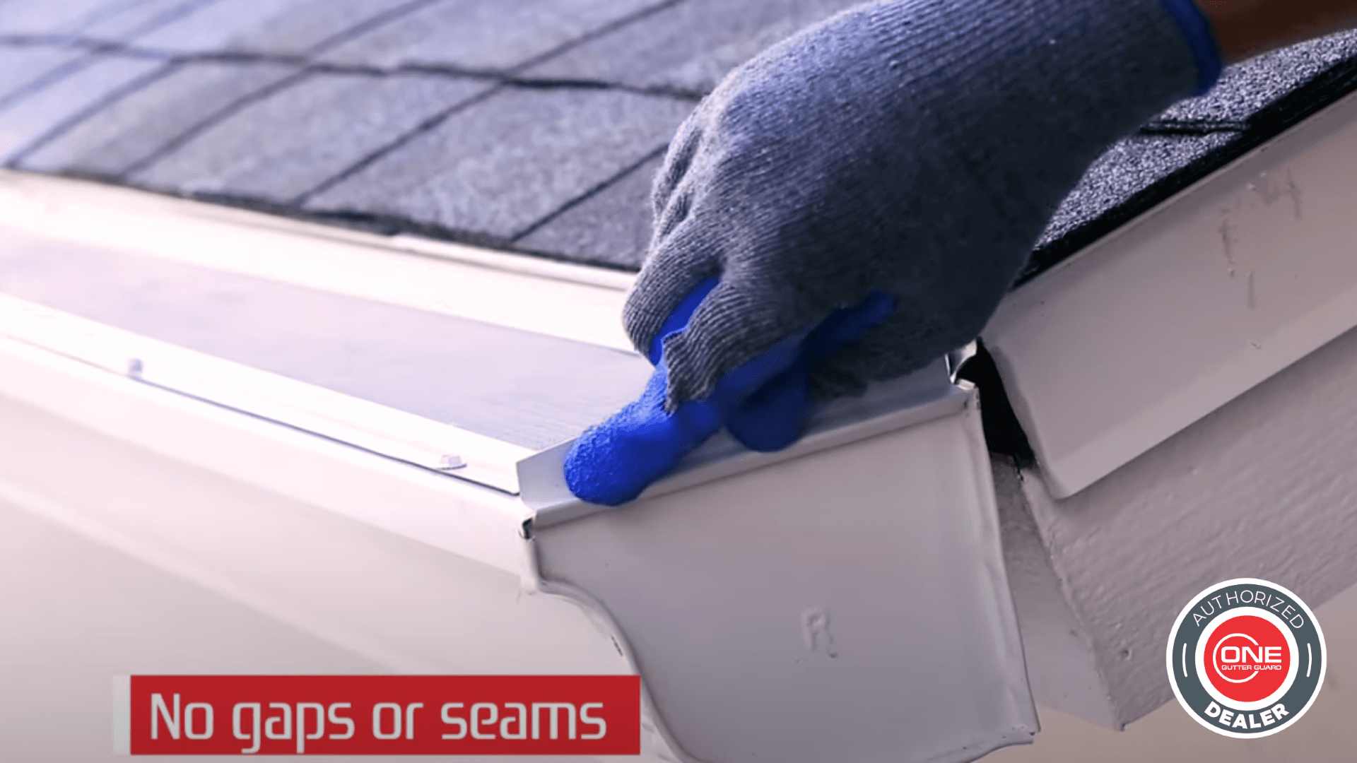 A worker installs ONE Gutter Guard™ demonstrating that there are no gaps or seams.