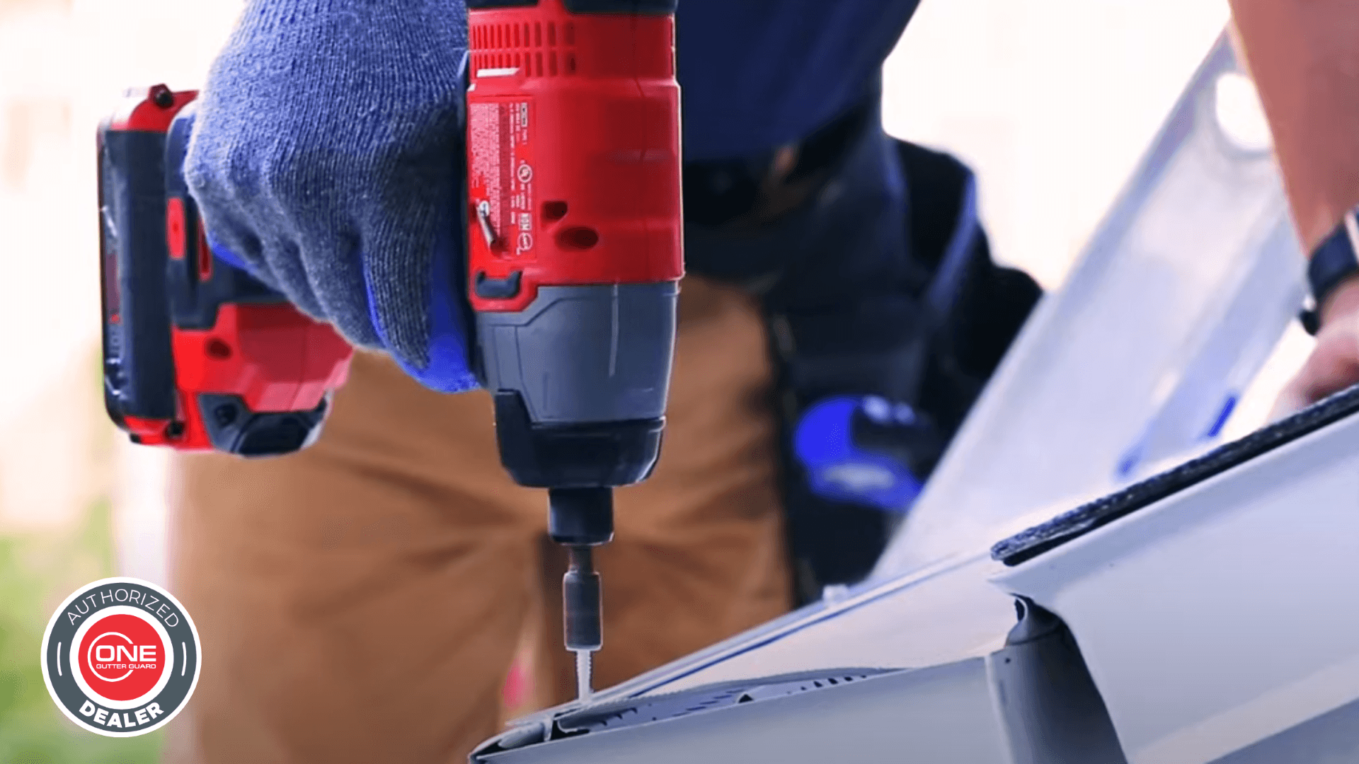 A worker uses a drill to install ONE Gutter Guard™.